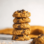 Stack of chewy healthy pumpkin oat cookies with chocolate chips on a light background