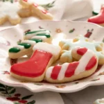 Close up of glossy Sugar Cookie Icing on Christmas stocking and candy cane cookies