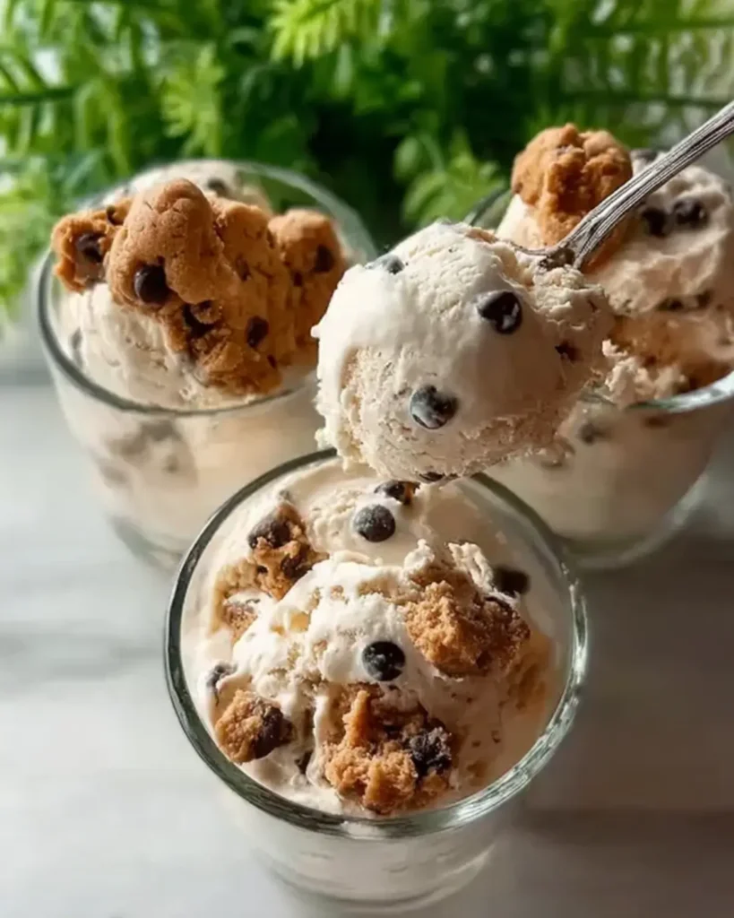 Scoops of cookie dough ice cream with chocolate chips served in small glass cups.