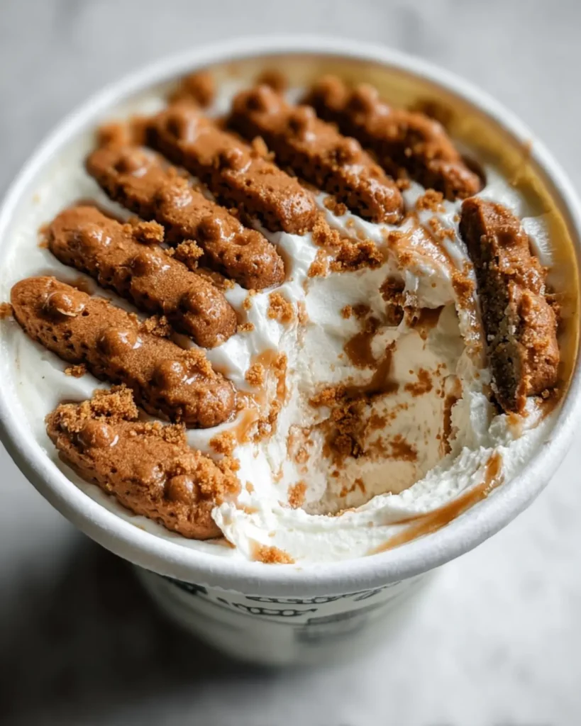 Half-eaten yogurt cup showing softened Biscoff cookies layered with thick yogurt, demonstrating the viral 2 Ingredient Japanese Cheesecake texture.