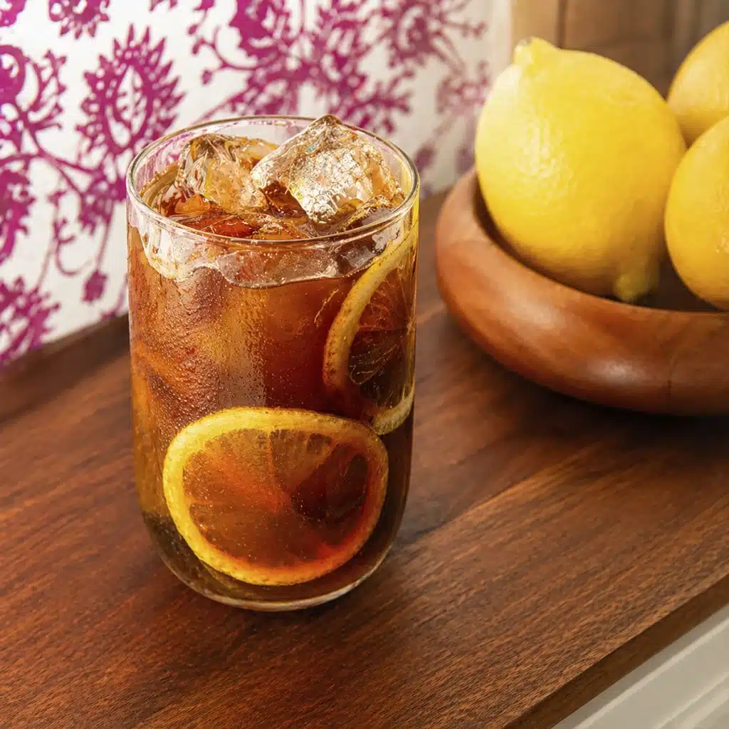 Mazagran Coffee served over ice with fresh lemon slices in a glass