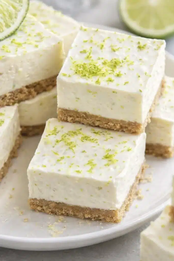 No Bake Margarita Cheesecake Bites squares served on plate with lime slices