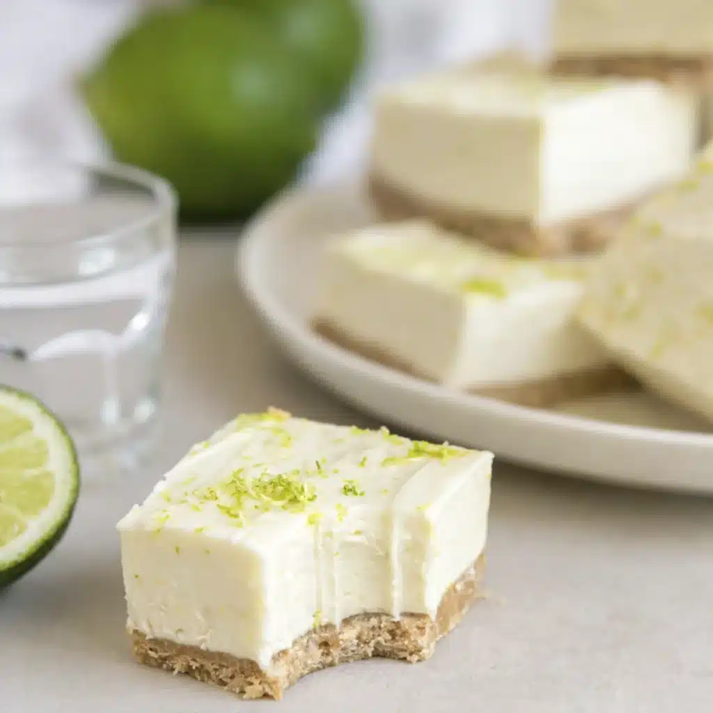 Stacked No Bake Margarita Cheesecake Bites with lime zest and graham crust on a plate