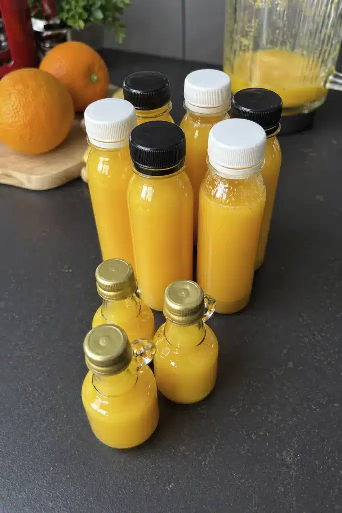 Homemade turmeric ginger lemon shots stored in small bottles ready for daily consumption