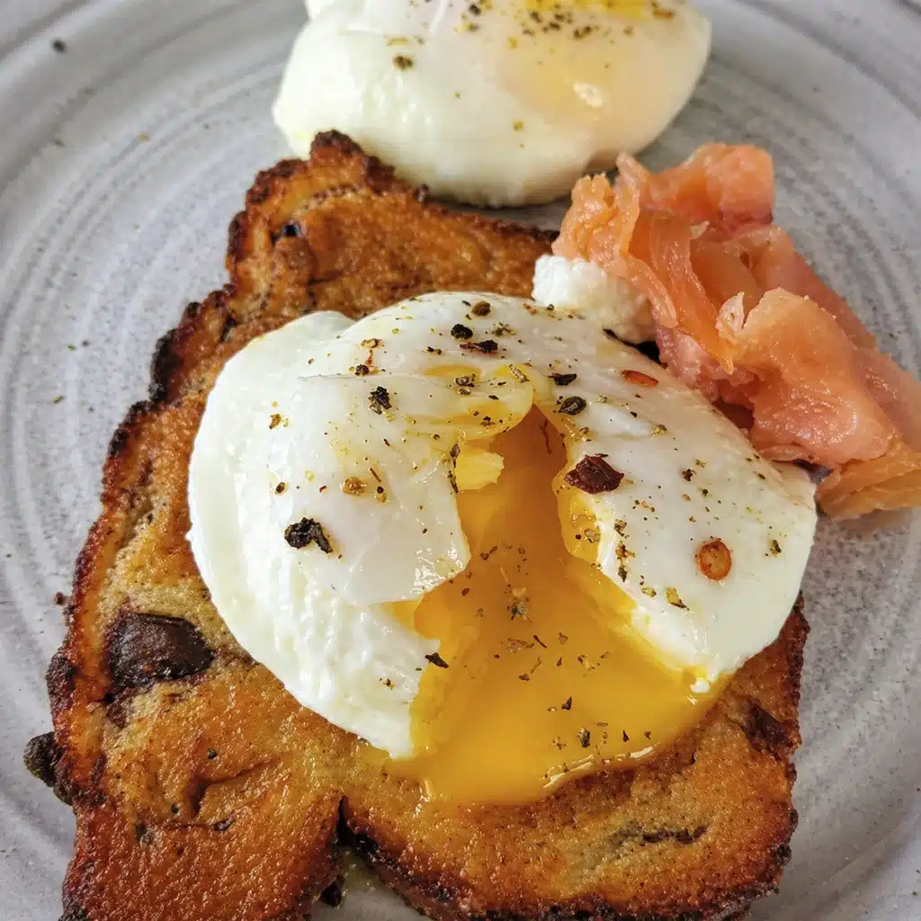 Air fryer poached egg served on crispy toast with seasoning and soft cooked egg white