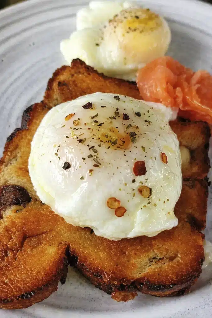 Air fryer poached eggs with runny yolk served on crispy toasted bread with smoked salmon