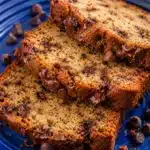 Sliced banana bread with melted chocolate chips on a blue plate