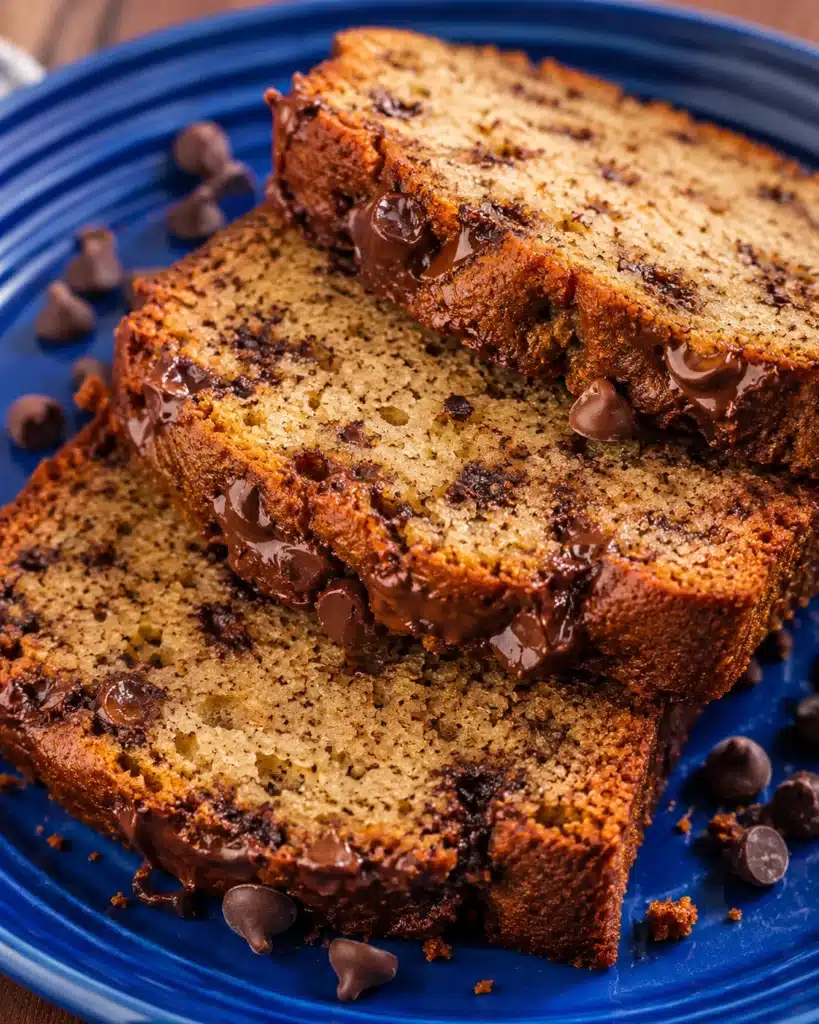 Sliced banana bread with melted chocolate chips on a blue plate