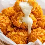 Crispy cheese bites with melted cheese being pulled from the center