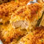 Golden baked chicken breast with crispy cheddar crumb topping lifted from a creamy casserole dish