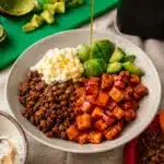 bowl with roasted sweet potatoes ground beef cottage cheese avocado and honey drizzle