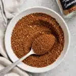 close up of taco seasoning blend in a white bowl with a spoon